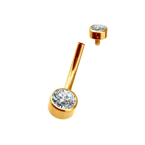 Alternative view of Piercing de ombligo. De titanio con baño de oro 24 Kt y 2 zirconias corte bisel